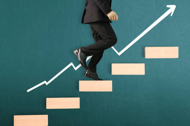 istock business person stepping up  toy staircase 992436062