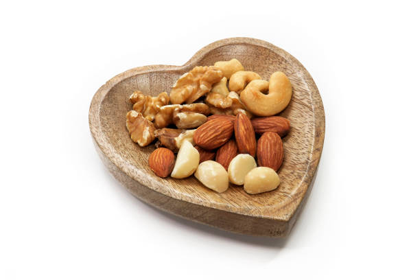 istock Nuts mix in a wooden plate 992437302