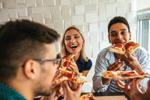 istock Grabbing a slice of pizza with friends 992447144