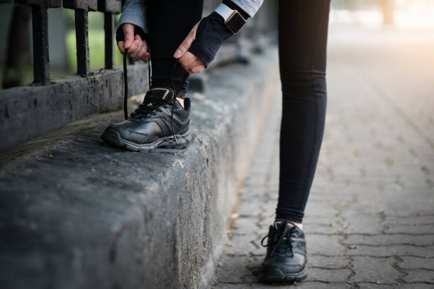 istock Sport runner woman tying laces before training. Marathon. 992461084