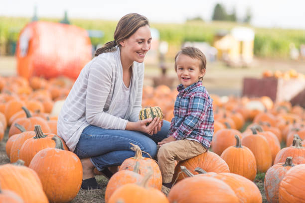istock Mom and her little boy at the pumpkin patch 992467798
