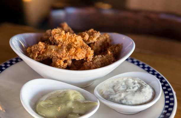 istock Deep fried Calamari Squid appetizer dish with dipping sauce closeup 992471732