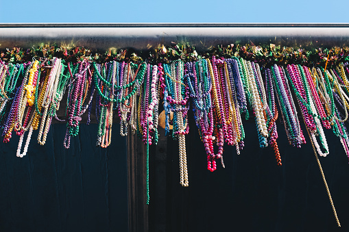 During Mardi Gras, the whole city of New Orleans gets covered in colorful plastic beads, even hanging from rooftops. Colorful and unexpected