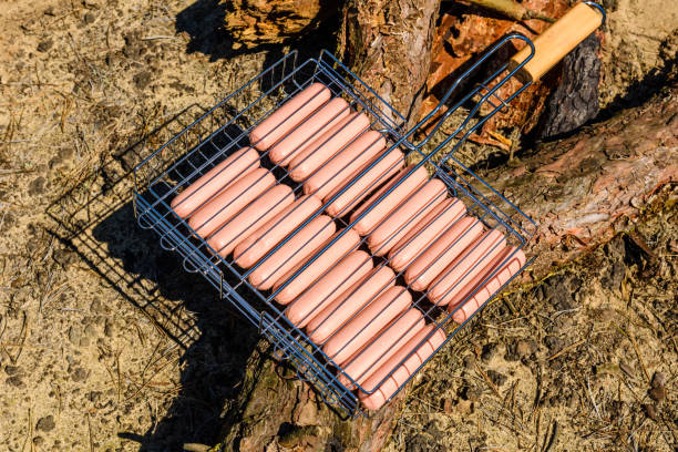 istock Raw sausages in a barbecue grill before cooking 992560324