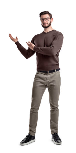 istock A relaxed young man in glasses looks in front while showing something on the side with his hands 992574368