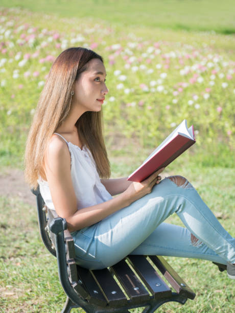 istock Student reading a book in the park. Ready to go to University. 992577342