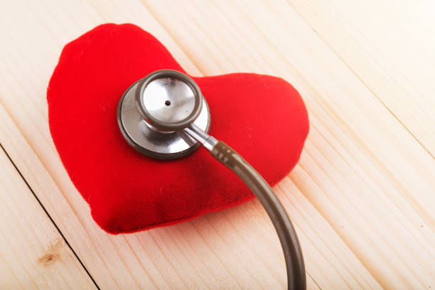 istock Valentines day background. Red heart on wooden table with copy space 992579398