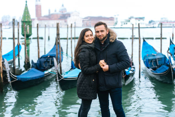 istock guy and girl posing in the background gondolas 992595540