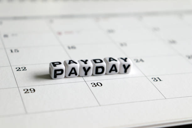 istock A white cube arranged in the word ’PAY DAY ' on the calendar. Payday concept. 992598084