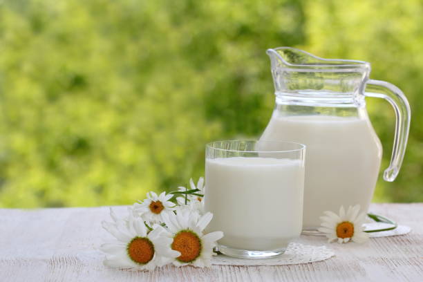 istock Fresh milk in glass on natural background 992619854