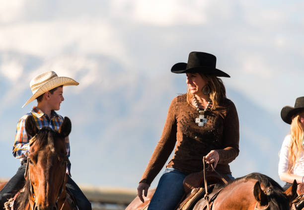 istock Mom and son out horseback riding together 992632800