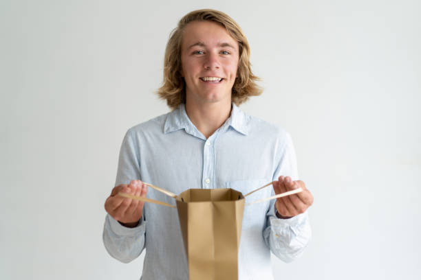istock Happy excited shopaholic checking package content 992645796