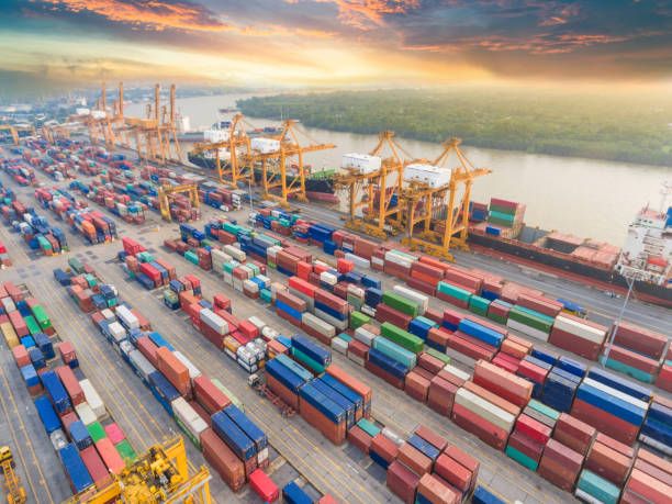 istock Logistics and transportation of Container Cargo ship and Cargo working crane bridge in shipyard 992658546