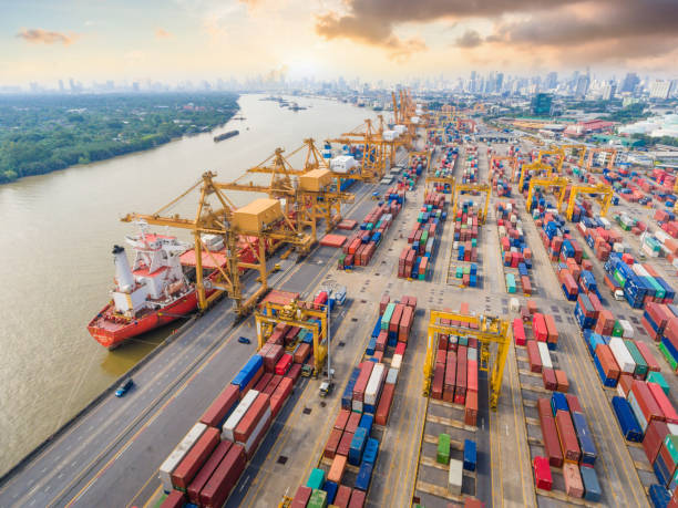istock Logistics and transportation of Container Cargo ship and Cargo working crane bridge in shipyard 992659692