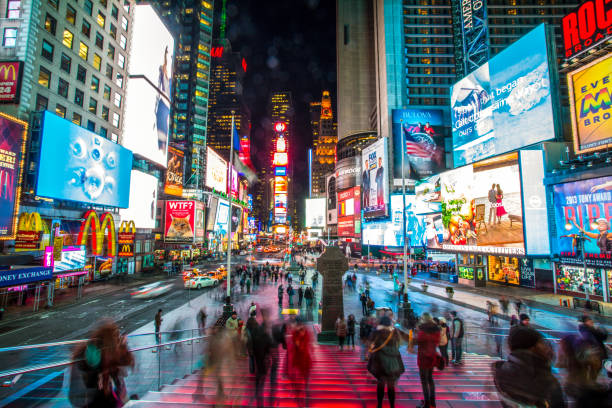 Times Square, New York City Manhattan, New York/United States - January 8, 2014: On a cold winter's evening in the middle of a colorfully illuminated Times Square. stadium advertising stock pictures, royalty-free photos & images