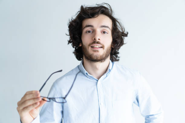 istock Calm dark-haired man holding glasses 992667620
