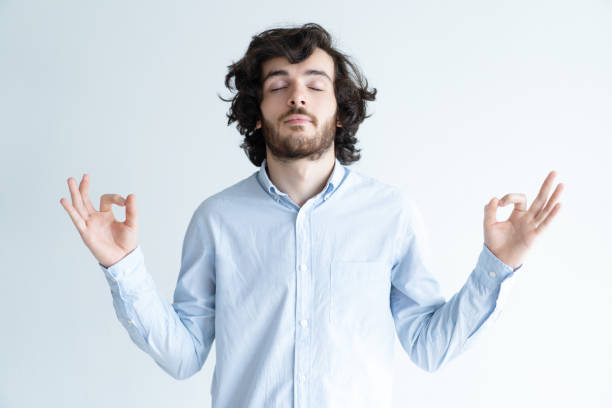istock Peaceful young man meditating with his eyes closed 992667746