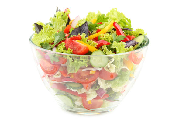 istock Vegetable salad in glass bowl isolated on white 992668048