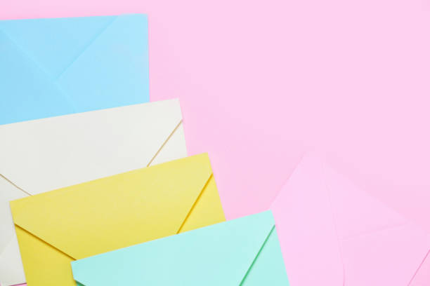 istock Frame from colorful envelopes on pink table top view. 992691834