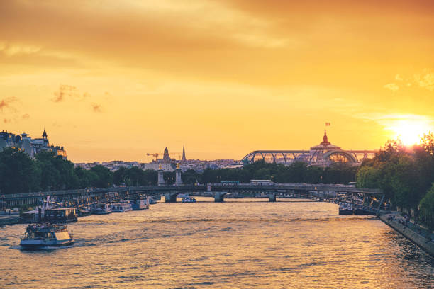 istock Paris at sunset with Eiffel Tower, Grand Palais and Seine river 992692912