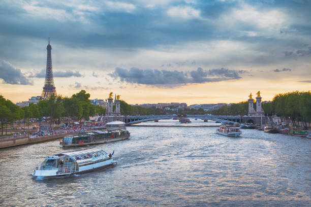 Paris at sunset with Eiffel Tower, Alexander III bridge and Seine river