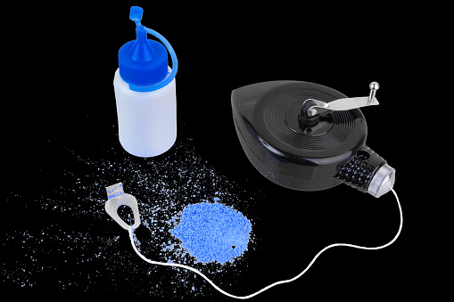 Chalk line and blue paint isolated on black background