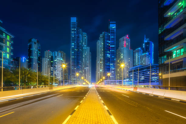 istock Modern buildings and illuminated road of Dubai UAE 992706252