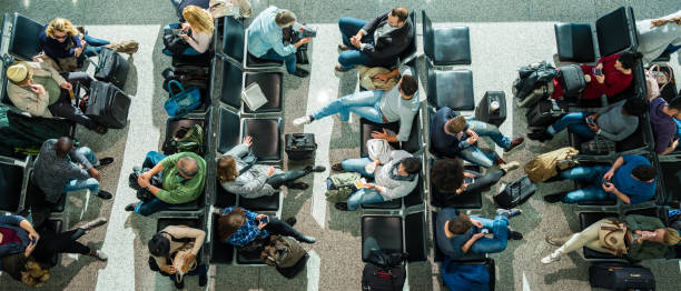 Business people in departure lounge Business people waiting at airport in departure lounge. airport departure area stock pictures, royalty-free photos & images
