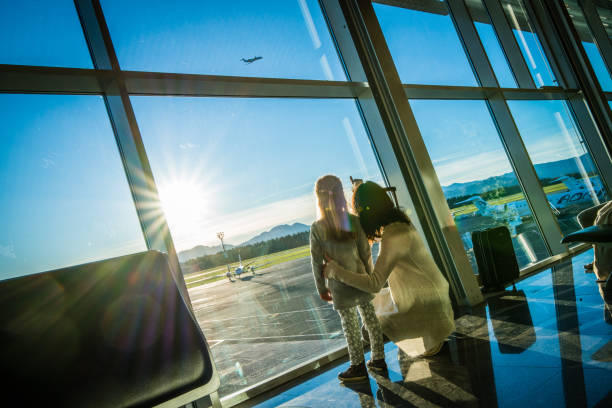 Mother showing aeroplane to daughter