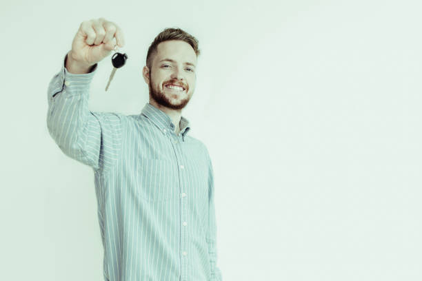 istock Happy sales manager holding car or house key 992710372