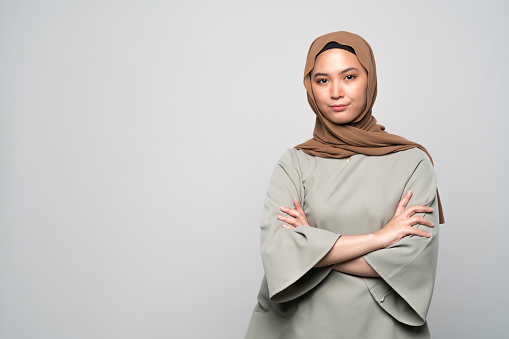 Portrait of a young Malaysian woman in traditional Muslim clothing.