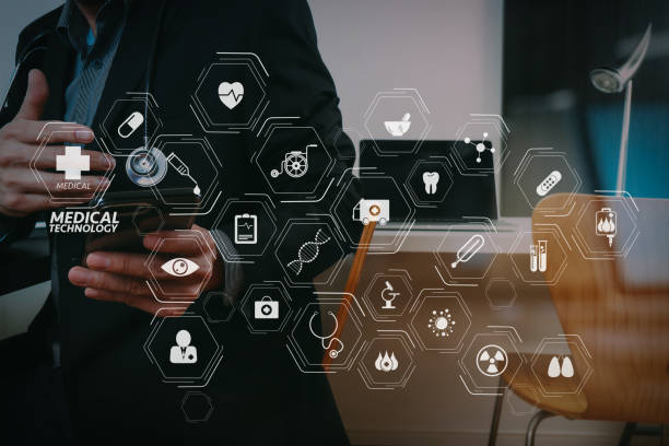 istock smart medical doctor working with smart phone and digital tablet and laptop computer on dark wooden desk in modern office with glass reflected view 992714112
