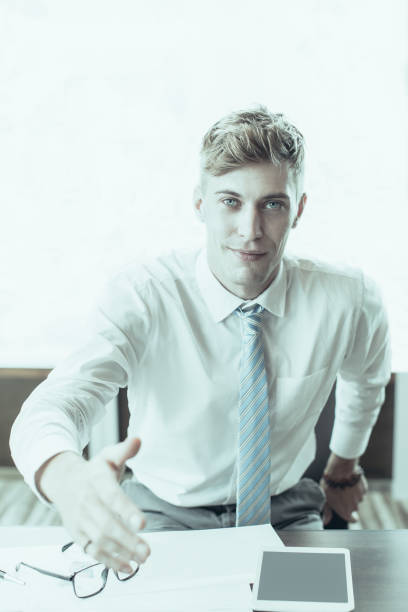istock Friendly Business Man Extending Arm for Handshake 992714344