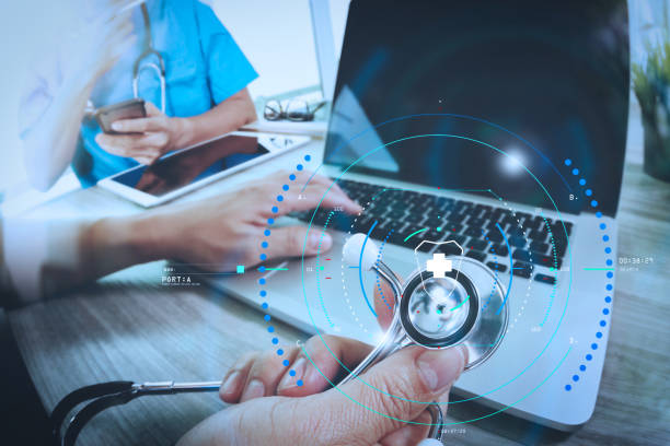 istock Medicine doctor hand working with modern computer and digital pro tablet with blank screen with his team on wooden desk as medical concept 992723054