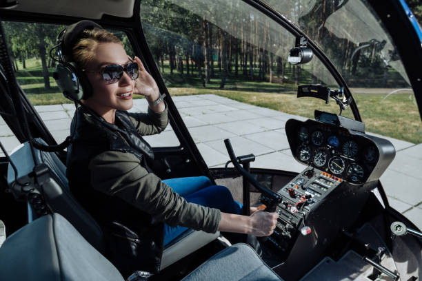 istock Gorgeous female helicopter pilot being about to start flight 992723338