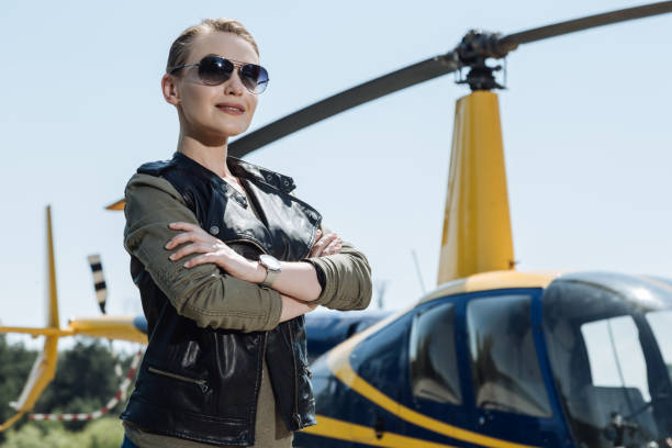 istock Gorgeous female pilot posing before taking helicopter ride 992723496
