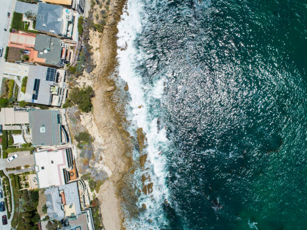 This pictures shows towering cliff and rippling water surface.