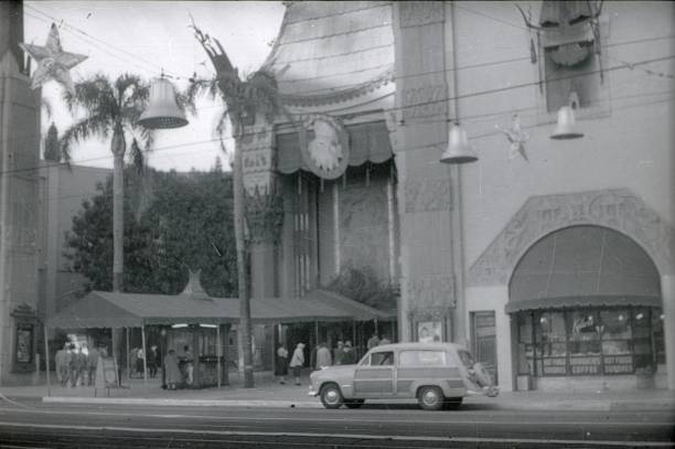 The TCL China Theater on Hollywood Boulevardd in Los Angeles, 1951 Los Angeles, California, USA, 1951. Established as a premiere cinema in the style of a Chinese Pagoda, is one of the most famous tourist sites in Los Angeles. Also world-famous through the hand and shoe prints of numerous movie stars immortalized in cement slabs in the entrance area of the cinema. hollywood california photos stock pictures, royalty-free photos & images