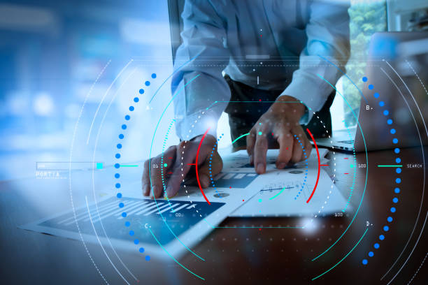 istock business documents on office table with smart phone and digital tablet and graph business diagram and man working in the background 992730804