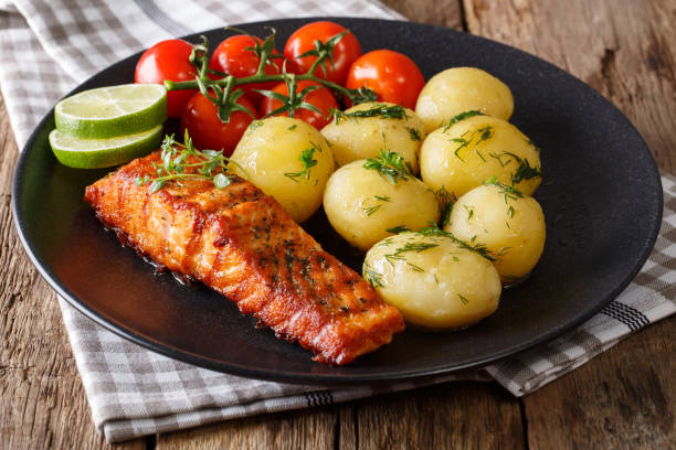 istock grilled salmon and boiled new potatoes, fresh tomatoes close-up. horizontal 992733964