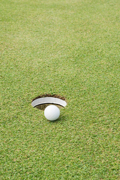 istock Close up of golf ball on green 992739114