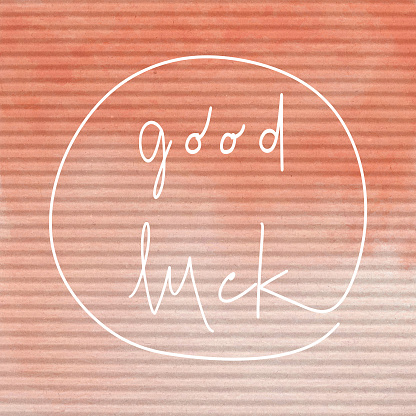 Good Luck. Inspirational quote on orange corrugated paper.