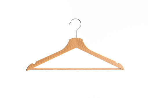 Wooden coat hanger isolated against bright white background