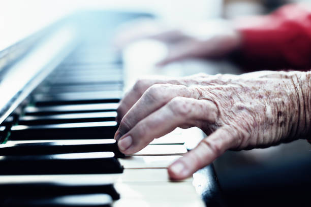 istock Senior woman's hands playing the piano 992747702