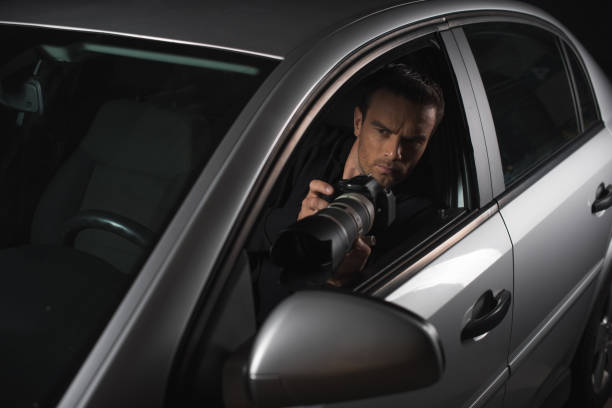 istock male paparazzi doing surveillance by camera with object glass from his car 992753194