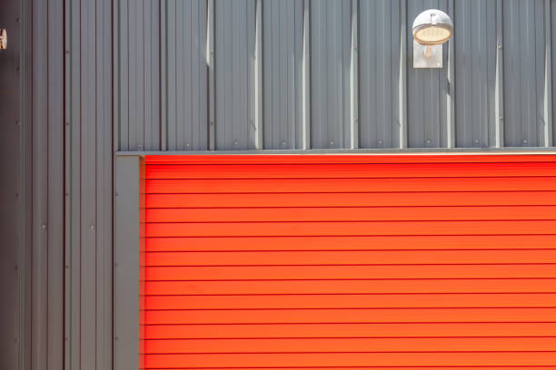 Industrial design. Bright red metal warehouse building roller shutter door.