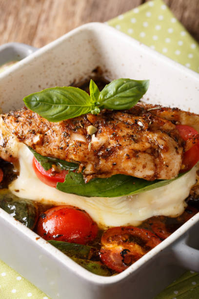 istock Balsamic chicken fillet baked with caprese close-up in a baking dish. vertical 992757604