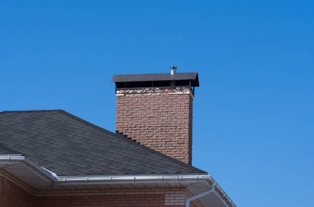 istock Modern brick chimney with beautiful forge under clear blue sky 992759472