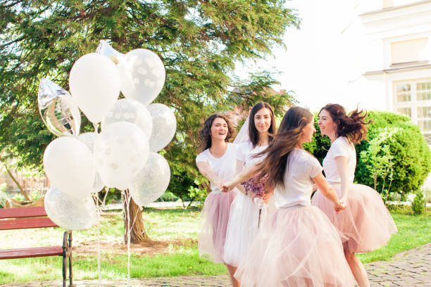 istock Bride with friends in the summer park 992765832