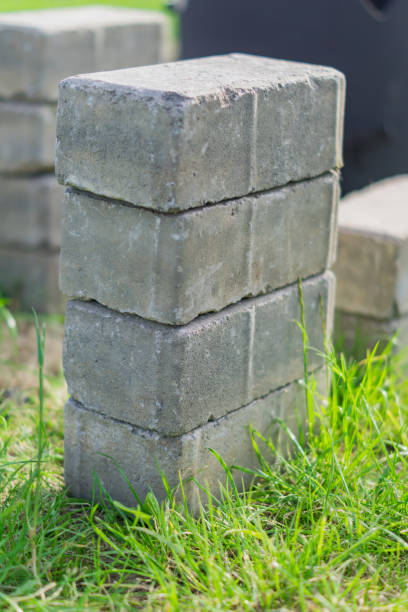 istock pile of pavement gray bricks on green grass 992770192